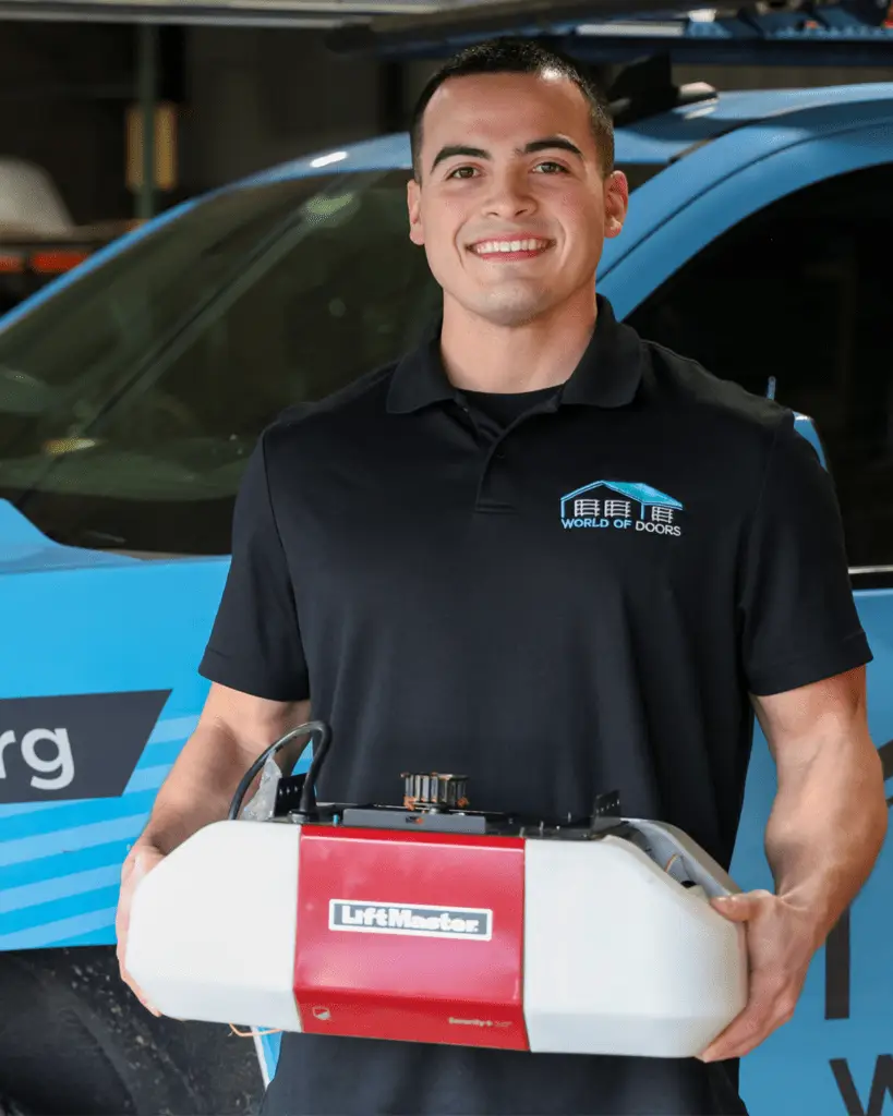 Nick, the specialist, is holding a garage door opener. The article discusses about garage door opener issues.