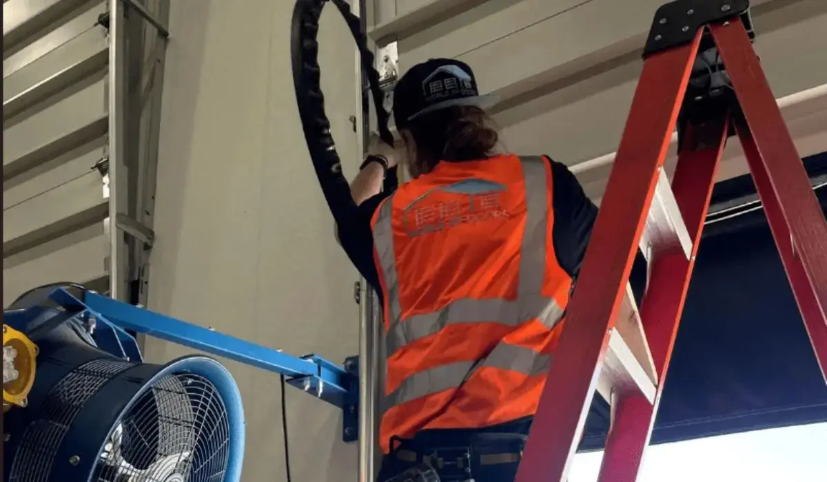 Professional garage door technician fixing overhead door during emergency service in metro Chicago.