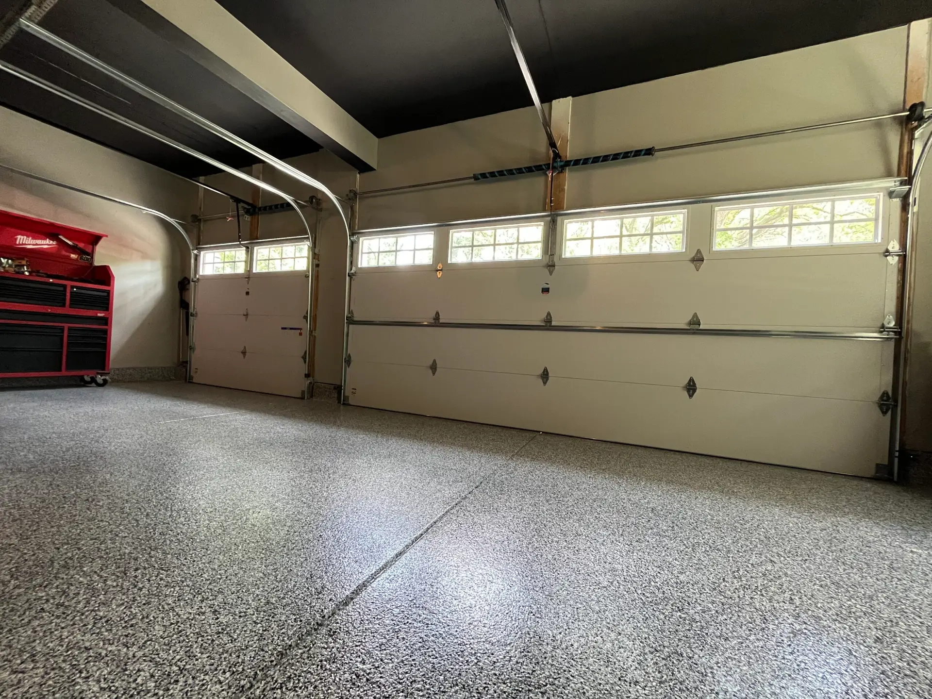 Interior view of a garage with overhead doors installed by commercial door repair companies, highlighting commercial overhead door repair services.