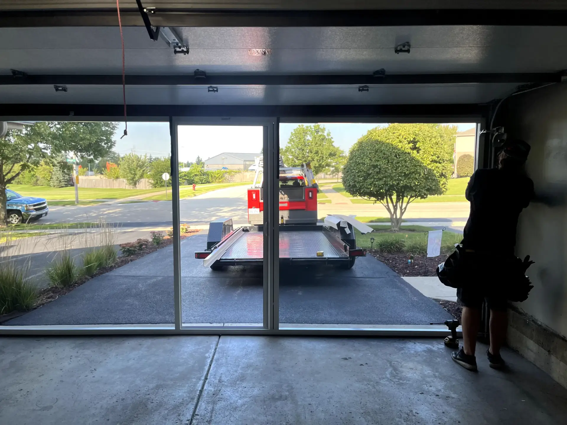 A technician installed a garage door. A guide picture for a blog about Garage Door Installation.